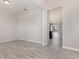 Open-concept living room with plank flooring, leading into the home, showcasing its seamless design at 8058 Corkfield Ave, Orlando, FL 32832