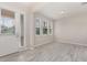 Bright, open-concept living room with neutral walls, white trim, and wood-look tile floors at 8058 Corkfield Ave, Orlando, FL 32832