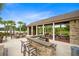 Outdoor kitchen and grilling area with stone countertops, picnic tables, and a covered pavilion at 8058 Corkfield Ave, Orlando, FL 32832