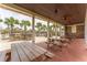 Covered pavilion with brick flooring, picnic tables, and a stone barbecue area overlooking palm trees at 8058 Corkfield Ave, Orlando, FL 32832