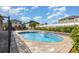 The backyard boasts a sparkling pool with a small waterfall and brick paver patio at 8058 Corkfield Ave, Orlando, FL 32832