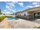 Backyard view of the fenced in pool and brick paver patio, perfect for entertaining guests at 8058 Corkfield Ave, Orlando, FL 32832