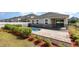 Backyard view of the sparkling pool, patio and fenced in yard with tasteful landscaping at 8058 Corkfield Ave, Orlando, FL 32832