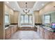 Luxury bathroom with dual vanities, soaking tub, and decorative columns at 9138 Pinnacle Cir, Windermere, FL 34786