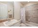 Cozy bathroom features a shower-tub combo and vanity with granite countertop at 9138 Pinnacle Cir, Windermere, FL 34786