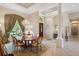 Open-concept dining area with a chandelier, large windows, and direct access to the front entrance at 9138 Pinnacle Cir, Windermere, FL 34786