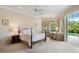Bright main bedroom with ceiling fan, outdoor access, and decorative accents at 9138 Pinnacle Cir, Windermere, FL 34786