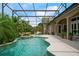 A private backyard pool and spa with a waterfall feature is surrounded by lush tropical landscaping at 9138 Pinnacle Cir, Windermere, FL 34786