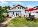 Relaxing backyard with a manicured lawn and outdoor seating area with a red umbrella at 1017 Florida Ave, St Cloud, FL 34769