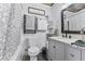 Cozy bathroom featuring stylish vanity, a decorative mirror, and fresh white walls at 1017 Florida Ave, St Cloud, FL 34769