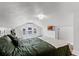Bright bedroom with large bed, dark wood floors, white dresser, neutral walls and natural light at 1017 Florida Ave, St Cloud, FL 34769