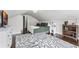 Bright bedroom boasts an eye-catching rug, hardwood floors, modern furniture, and neutral walls for a relaxing space at 1017 Florida Ave, St Cloud, FL 34769