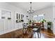 Bright dining area with hardwood floors, glass table, chandelier, and built-in shelving at 1017 Florida Ave, St Cloud, FL 34769