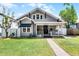 Charming home featuring a well-manicured lawn, brick walkway, and inviting front porch at 1017 Florida Ave, St Cloud, FL 34769