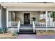Inviting front porch with a swing, potted plants, and a view of the neighborhood at 1017 Florida Ave, St Cloud, FL 34769
