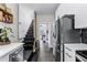 Bright kitchen area, stainless steel appliances, connecting to stairs at 1017 Florida Ave, St Cloud, FL 34769