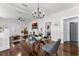 Open living space with hardwood floors, glass dining table, and fireplace at 1017 Florida Ave, St Cloud, FL 34769