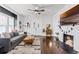 Cozy living room featuring hardwood floors, a decorative fireplace, and stylish furniture at 1017 Florida Ave, St Cloud, FL 34769