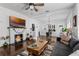 Open-concept living room with a fireplace, hardwood floors, and seamless flow to the dining area at 1017 Florida Ave, St Cloud, FL 34769