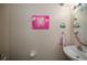 Half bathroom featuring a pedestal sink, round mirror, and decorative artwork on the walls at 127 Lake Emma Cove Dr # 127, Lake Mary, FL 32746