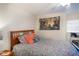 Cozy bedroom featuring a comfortable bed with colorful bedding and a window with natural light at 127 Lake Emma Cove Dr # 127, Lake Mary, FL 32746