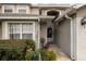 Inviting entrance featuring charming decor, colorful potted plants, and a glimpse of the front door at 127 Lake Emma Cove Dr # 127, Lake Mary, FL 32746