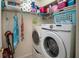 Laundry room with newer model washer and dryer and shelving above for storage at 127 Lake Emma Cove Dr # 127, Lake Mary, FL 32746