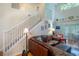 Open living area with high ceilings, staircase, a comfortable leather couch and neutral decor at 127 Lake Emma Cove Dr # 127, Lake Mary, FL 32746