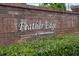 Feather Edge Condominium brick sign surrounded by lush greenery adds curb appeal and defines the community at 127 Lake Emma Cove Dr # 127, Lake Mary, FL 32746