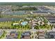 Aerial view of a vibrant community featuring a resort-style pool, clubhouse, and beautifully landscaped grounds at 2009 Tropical Palms Cir, Kissimmee, FL 34747