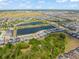 An aerial view showcases a Primary-planned community with lakes, lush landscaping, and meticulously arranged homes at 2009 Tropical Palms Cir, Kissimmee, FL 34747