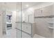 Modern bathroom with double vanity, granite countertop, glass shower, and tiled floor at 2009 Tropical Palms Cir, Kissimmee, FL 34747
