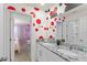 Fun bathroom featuring a double sink, Mickey Mouse wall art, and access to a princess themed bedroom at 2009 Tropical Palms Cir, Kissimmee, FL 34747