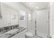Clean and modern bathroom with granite vanity, walk-in shower with glass door, and bright lighting at 2009 Tropical Palms Cir, Kissimmee, FL 34747