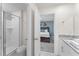 Bathroom featuring a glass-doored shower and toilet, and an open doorway to a bedroom with a blue accent wall at 2009 Tropical Palms Cir, Kissimmee, FL 34747