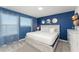 Blue bedroom featuring a queen bed, matching dresser with TV, and a window with a view to the neighborhood at 2009 Tropical Palms Cir, Kissimmee, FL 34747
