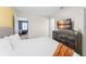 Bright bedroom featuring a cozy bed and dresser with TV, with a view into a fun living room at 2009 Tropical Palms Cir, Kissimmee, FL 34747