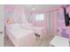 Adorable bedroom with pink canopy beds, princess murals, and pink and purple Mickey Mouse themed accent wall at 2009 Tropical Palms Cir, Kissimmee, FL 34747