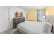 Comfortable bedroom with large bed, dresser, and window with blinds at 2009 Tropical Palms Cir, Kissimmee, FL 34747