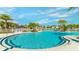 Stunning community pool surrounded by palm trees and lounge chairs, with well-maintained landscaping at 2009 Tropical Palms Cir, Kissimmee, FL 34747