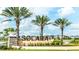 Landscaped community entrance sign with palm trees and manicured lawns, indicating a welcoming neighborhood at 2009 Tropical Palms Cir, Kissimmee, FL 34747