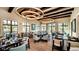Well lit dining room with multiple tables and chairs perfect for gatherings at 2009 Tropical Palms Cir, Kissimmee, FL 34747