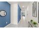 Bright hallway with ceramic floors, modern decor, and vibrant blue accent wall at 2009 Tropical Palms Cir, Kissimmee, FL 34747