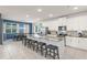 Bright kitchen with white cabinets, granite countertops, stainless steel appliances, and an island with barstool seating at 2009 Tropical Palms Cir, Kissimmee, FL 34747