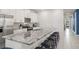 Modern kitchen with white cabinetry, granite countertops, and stainless steel appliances at 2009 Tropical Palms Cir, Kissimmee, FL 34747