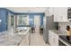 Modern open-concept kitchen with an island, stainless steel appliances, and a view into the dining room at 2009 Tropical Palms Cir, Kissimmee, FL 34747