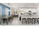 Open-concept kitchen with white cabinets, granite counters, and a breakfast bar with seating and stainless steel appliances at 2009 Tropical Palms Cir, Kissimmee, FL 34747