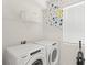 Efficient laundry room showcasing a modern washer and dryer setup with ample storage space at 2009 Tropical Palms Cir, Kissimmee, FL 34747