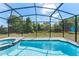 Private screened-in pool area with clear blue water and ample space for relaxation and recreation at 2009 Tropical Palms Cir, Kissimmee, FL 34747