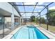 Backyard boasts a screened in pool and spa with a brick surround for outdoor relaxation at 2009 Tropical Palms Cir, Kissimmee, FL 34747